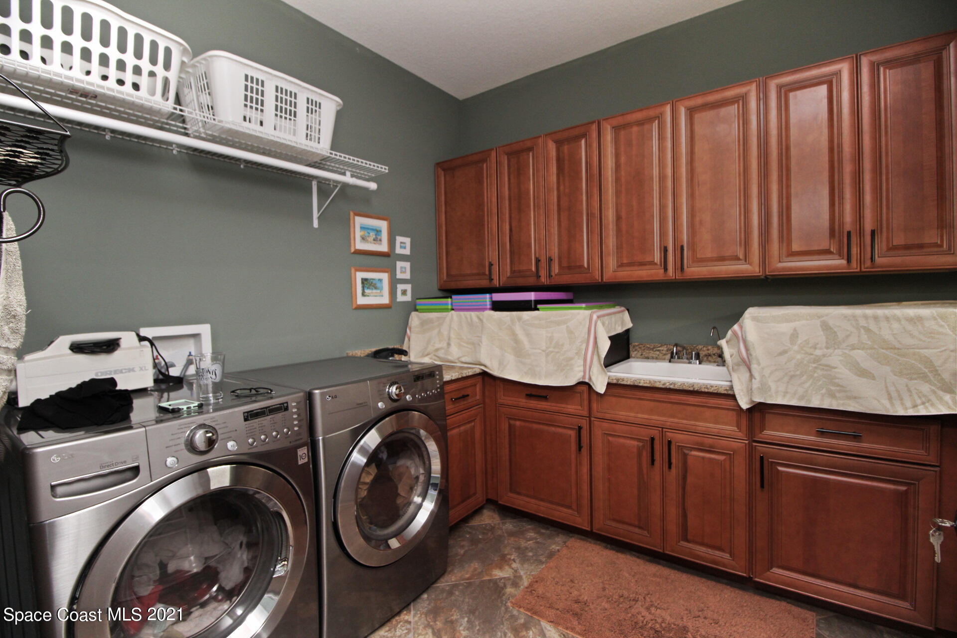 4034 Preservation Circle Melbourne, FL 32934 - Photo 20 of 25 a utility room with sink dryer and washer