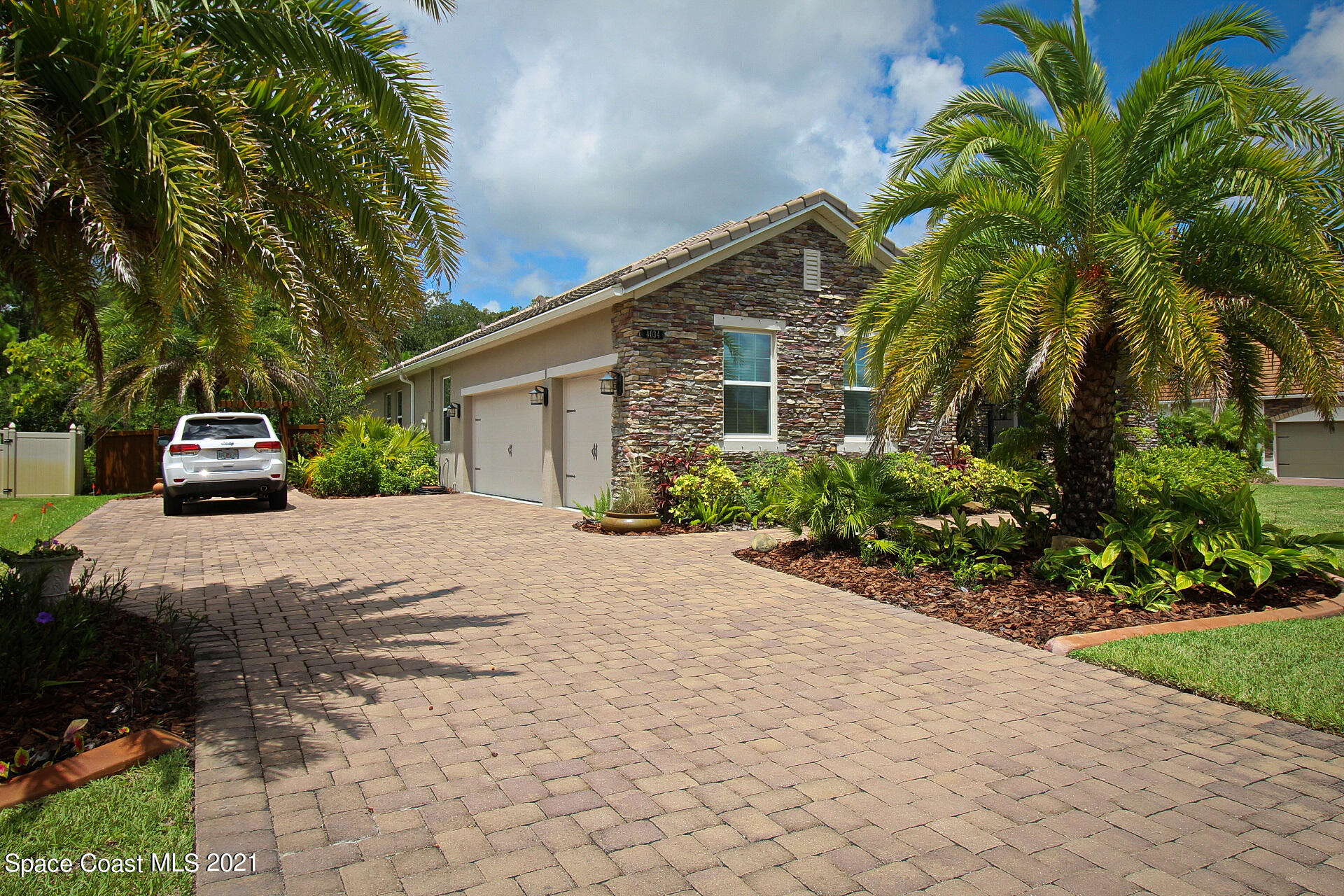 4034 Preservation Circle Melbourne, FL 32934 - Photo 3 of 25 a front view of a house with a yard and potted plants