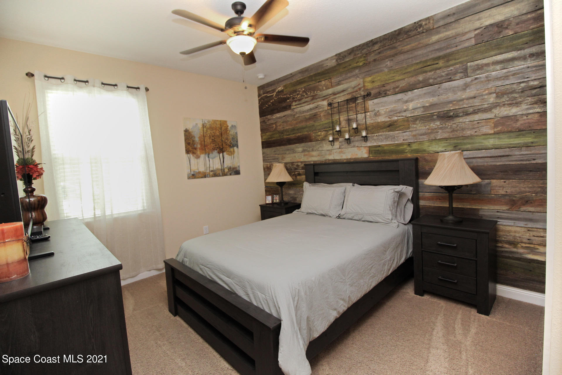 4034 Preservation Circle Melbourne, FL 32934 - Photo 22 of 25 a bedroom with a bed and a desk
