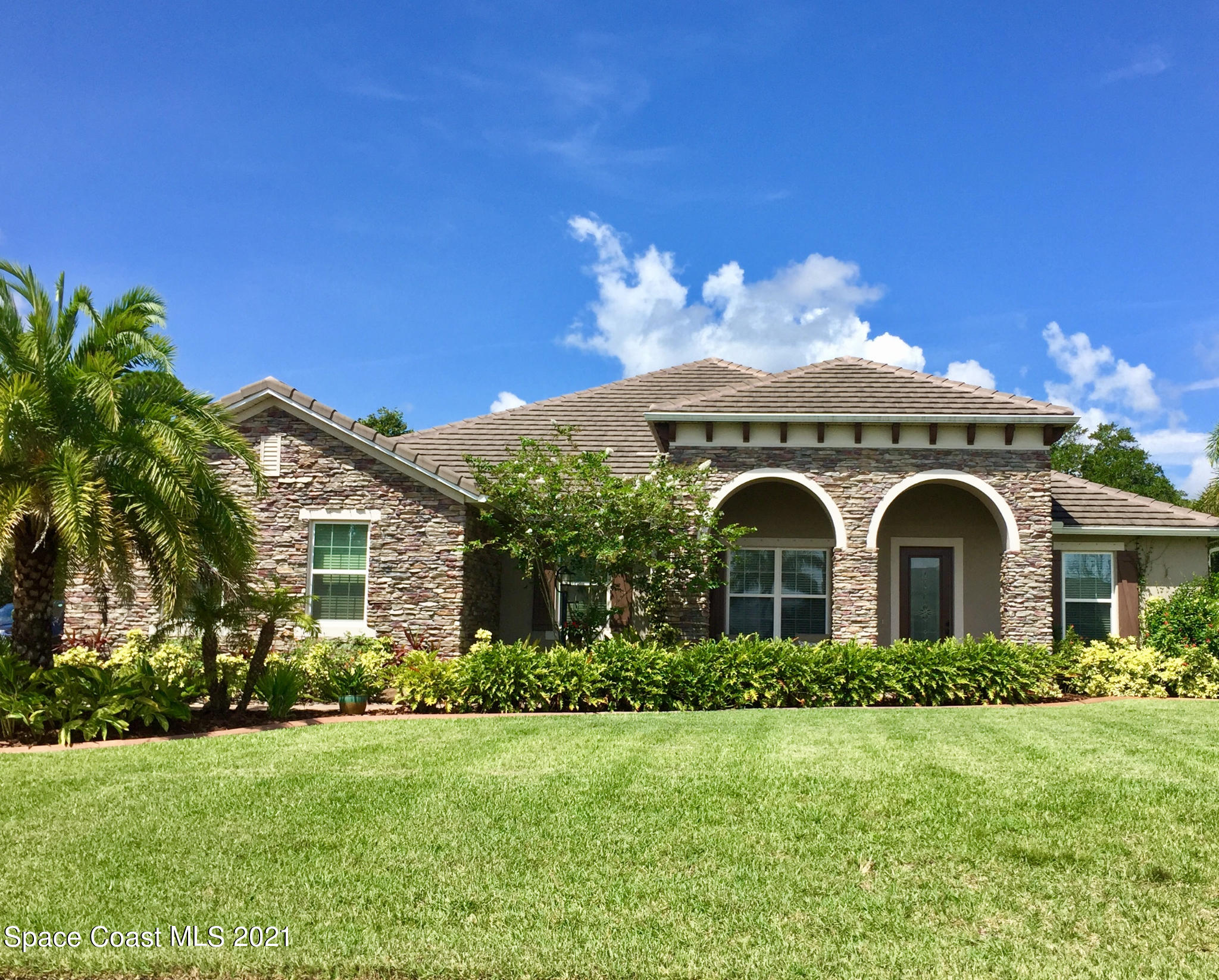 4034 Preservation Circle Melbourne, FL 32934 - Photo 25 of 25 a front view of a house with a garden
