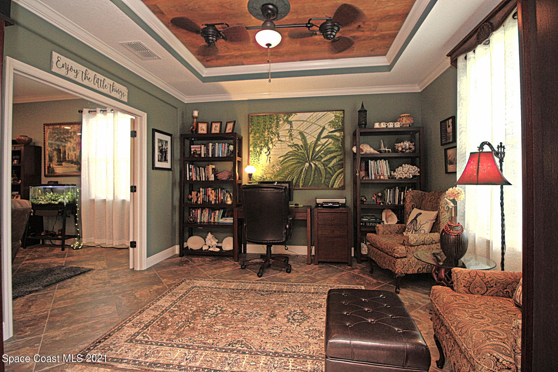 4034 Preservation Circle Melbourne, FL 32934 - Photo 9 of 25 a living room with furniture and a bookshelf