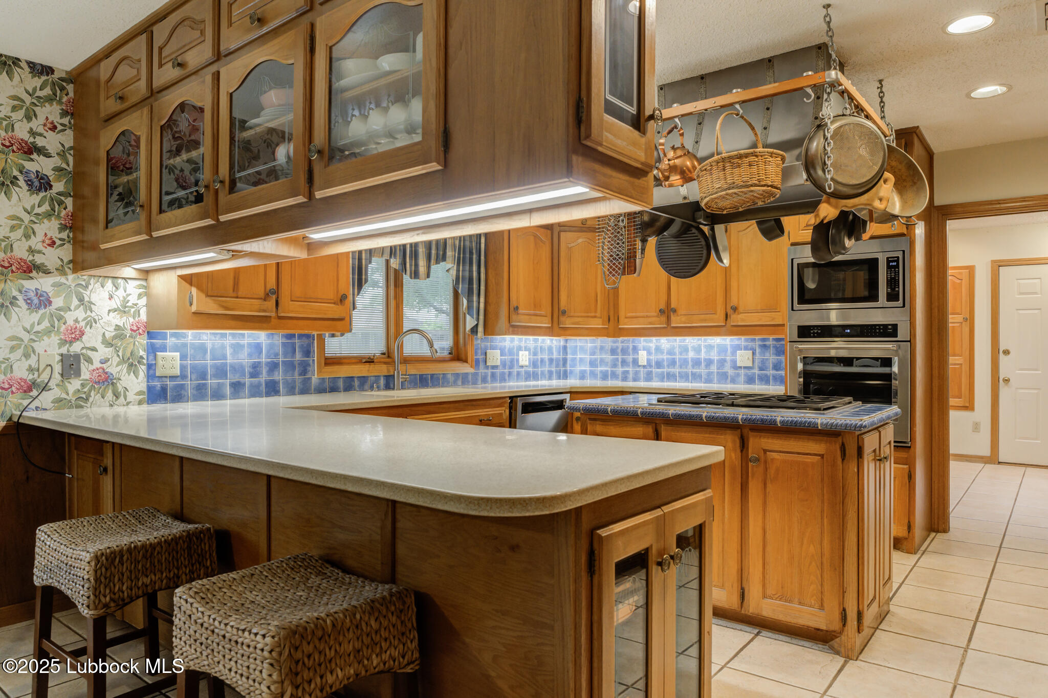 4206 89th Street Lubbock, TX 79423 - Photo 11 of 50 a kitchen with stainless steel appliances granite countertop a sink and a stove