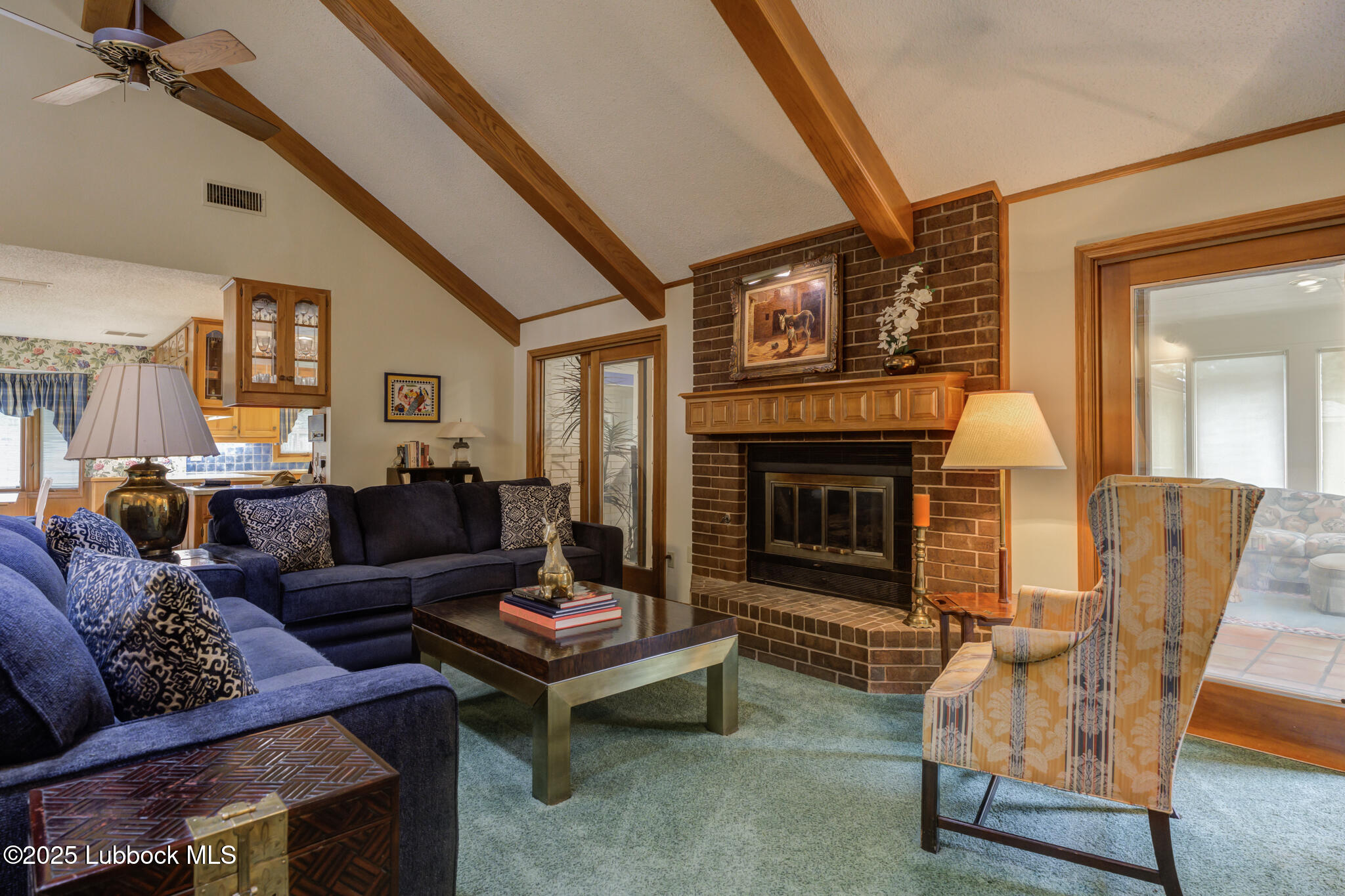 4206 89th Street Lubbock, TX 79423 - Photo 15 of 50 a living room with furniture and a fireplace