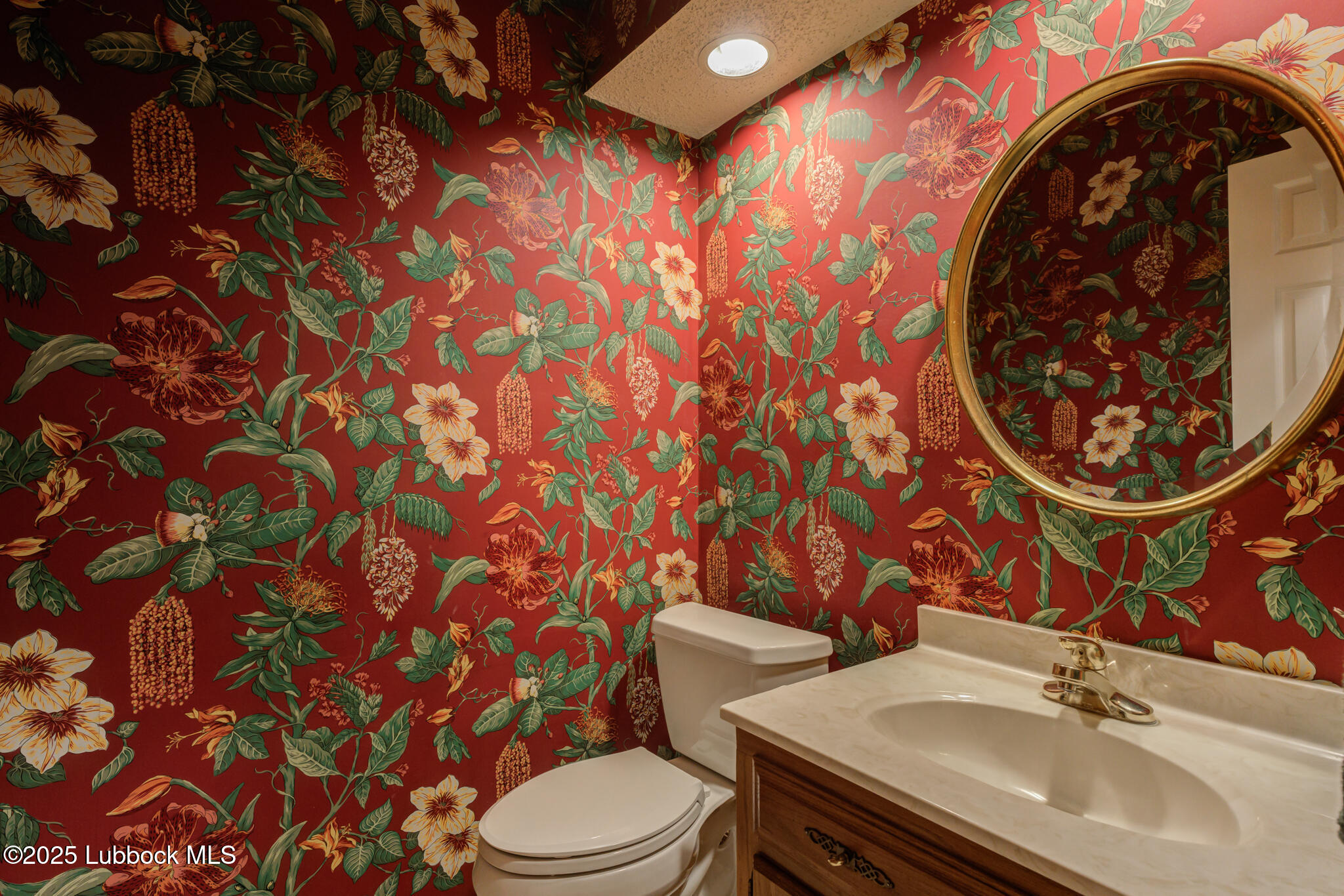 4206 89th Street Lubbock, TX 79423 - Photo 18 of 50 a bathroom with a sink and mirror with toilet