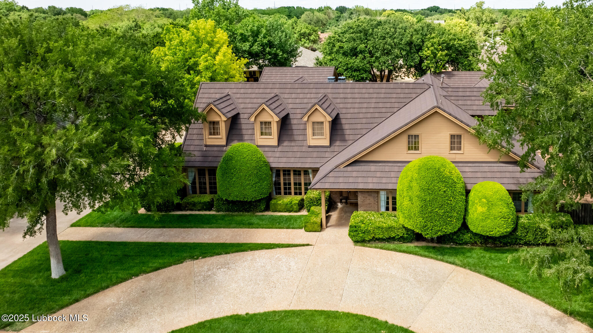 4206 89th Street Lubbock, TX 79423 - Photo 2 of 50 a view of a house with a small yard plants and large trees