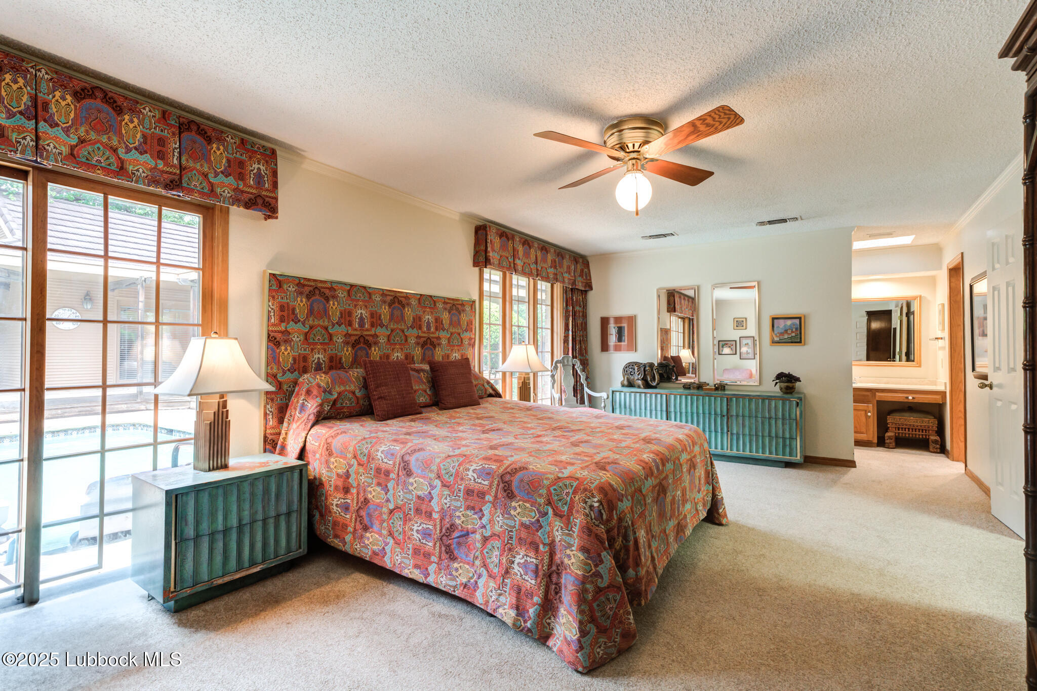 4206 89th Street Lubbock, TX 79423 - Photo 23 of 50 a bedroom with a bed and a chandelier