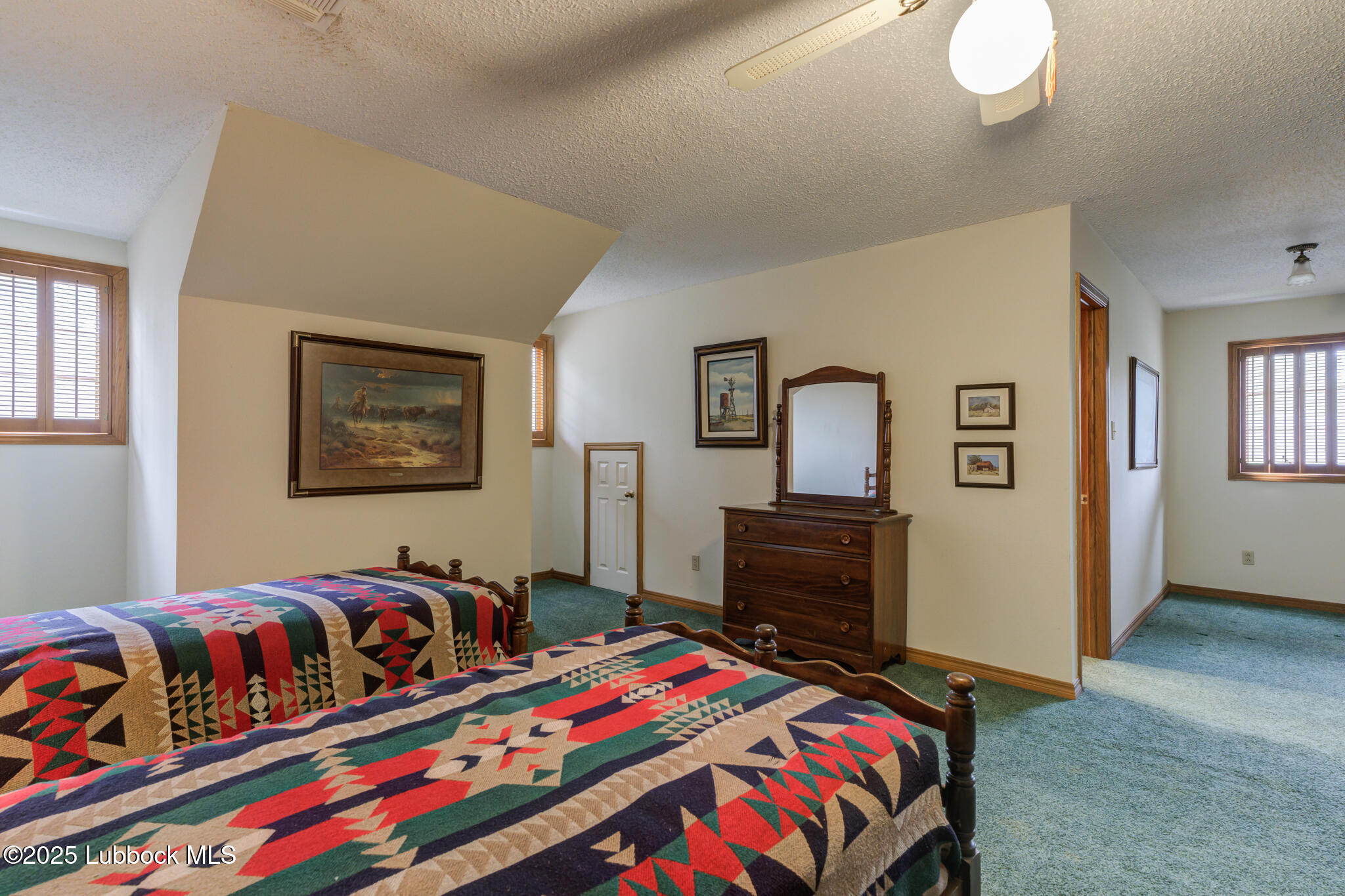4206 89th Street Lubbock, TX 79423 - Photo 30 of 50 a bedroom with a bed and a lamp on dresser