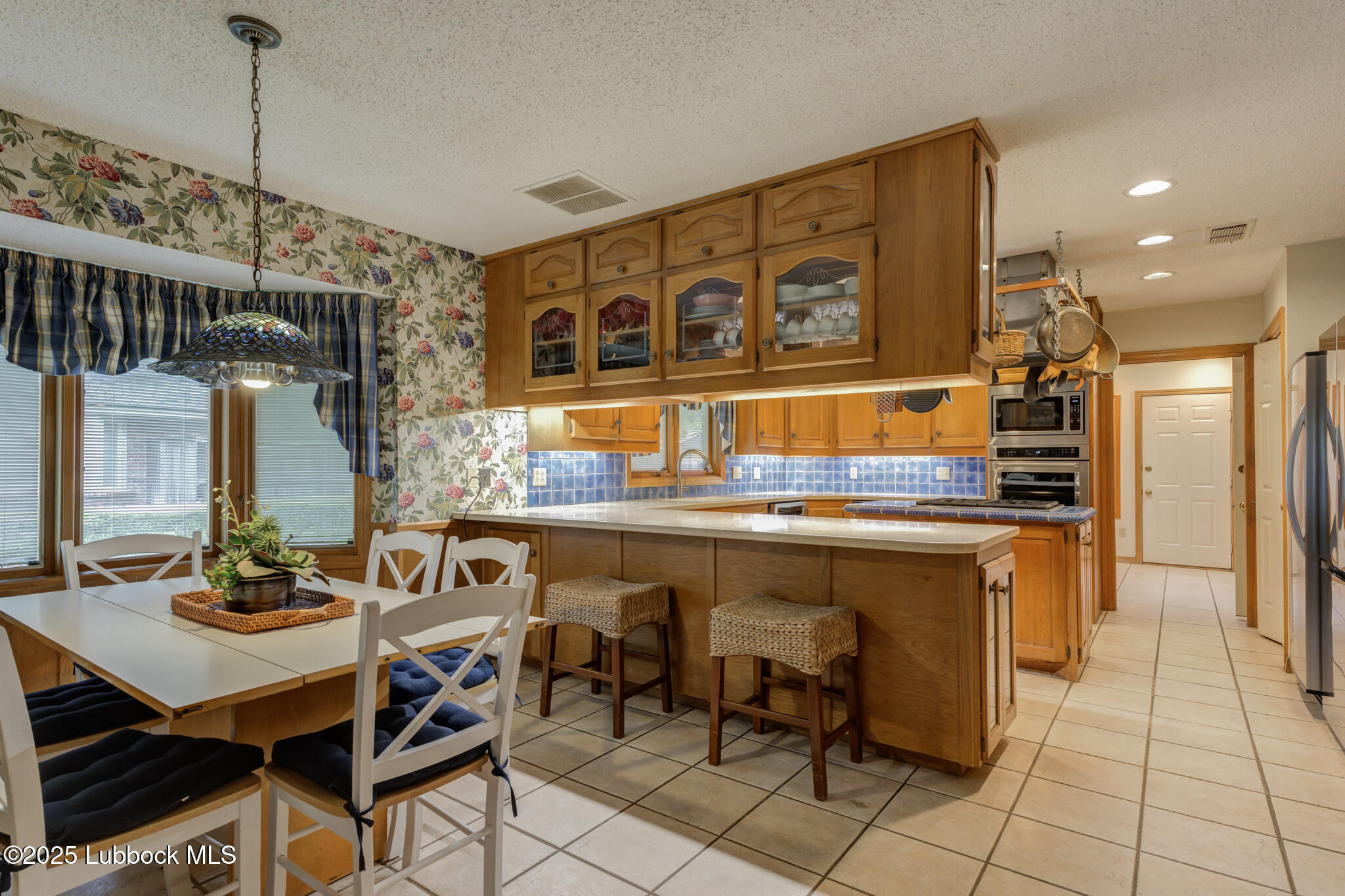 4206 89th Street Lubbock, TX 79423 - Photo 10 of 50 a kitchen with a sink and chairs
