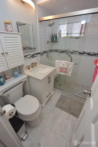 a bathroom with a sink a toilet and a mirror