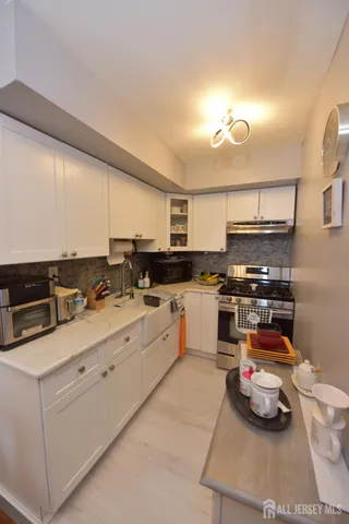 a kitchen with stainless steel appliances granite countertop a sink and cabinets