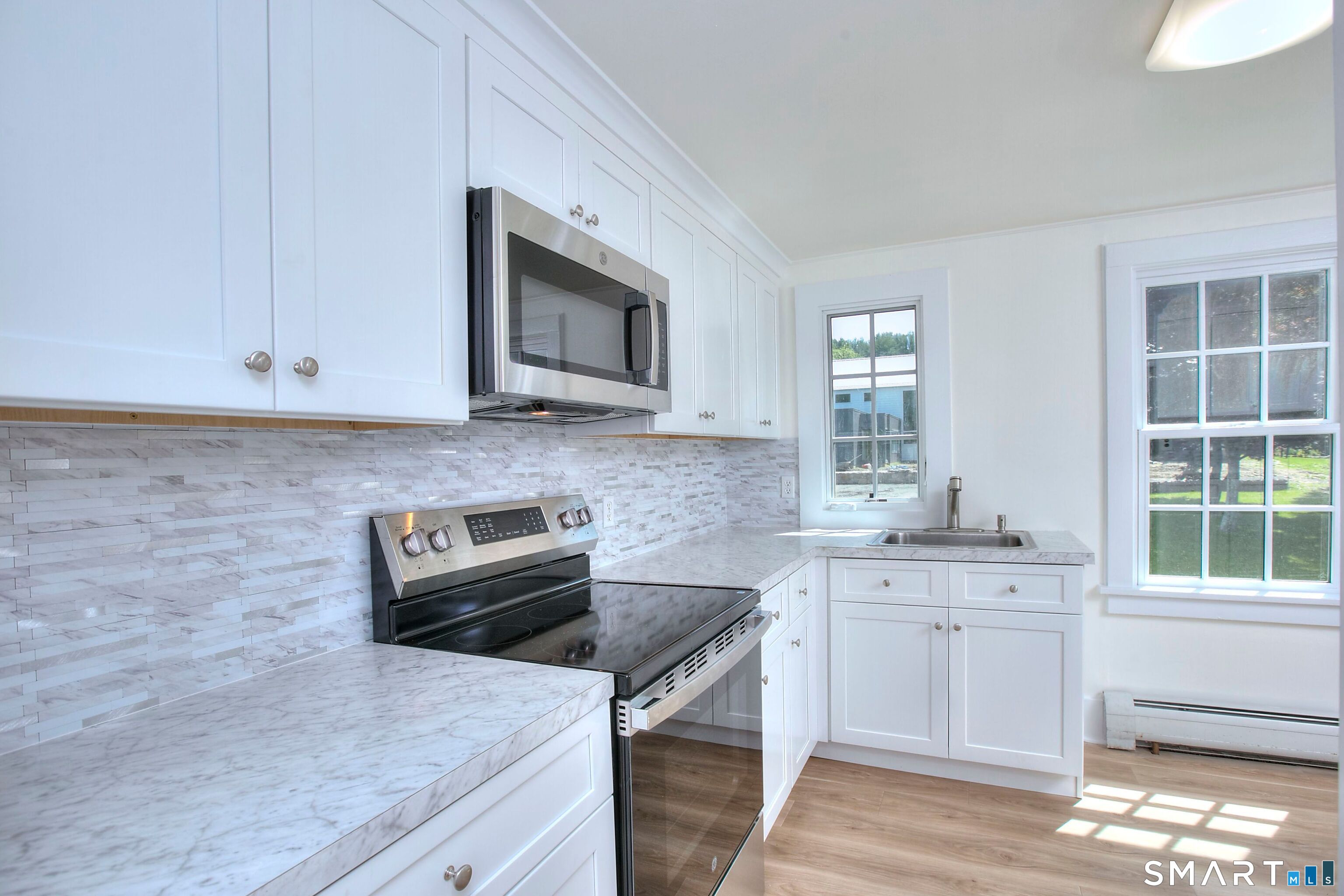 94 Honey Hill Road Wilton, CT 06897 - Photo 8 of 18 a kitchen with stainless steel appliances granite countertop a sink stove and microwave