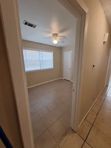 an empty room with windows and closet