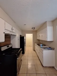 a kitchen with stainless steel appliances granite countertop a stove and a refrigerator