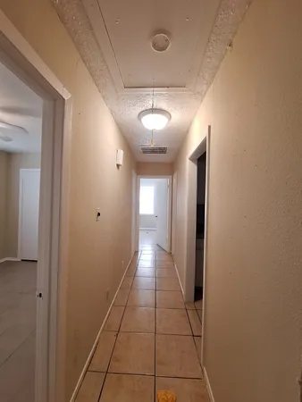 a view of a hallway with a chandelier