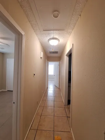 a view of a hallway with a chandelier