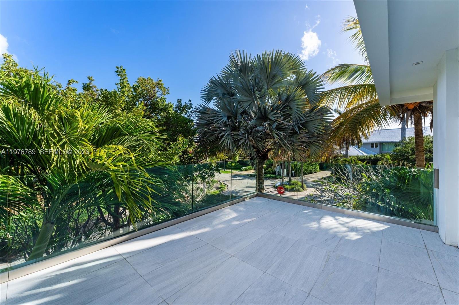 741 Harbor Drive Key Biscayne, FL 33149 - Photo 19 of 36 a view of a street with potted plants and palm trees