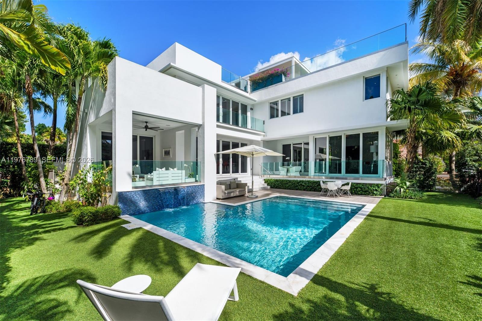 741 Harbor Drive Key Biscayne, FL 33149 - Photo 2 of 36 a view of an house with swimming pool and porch