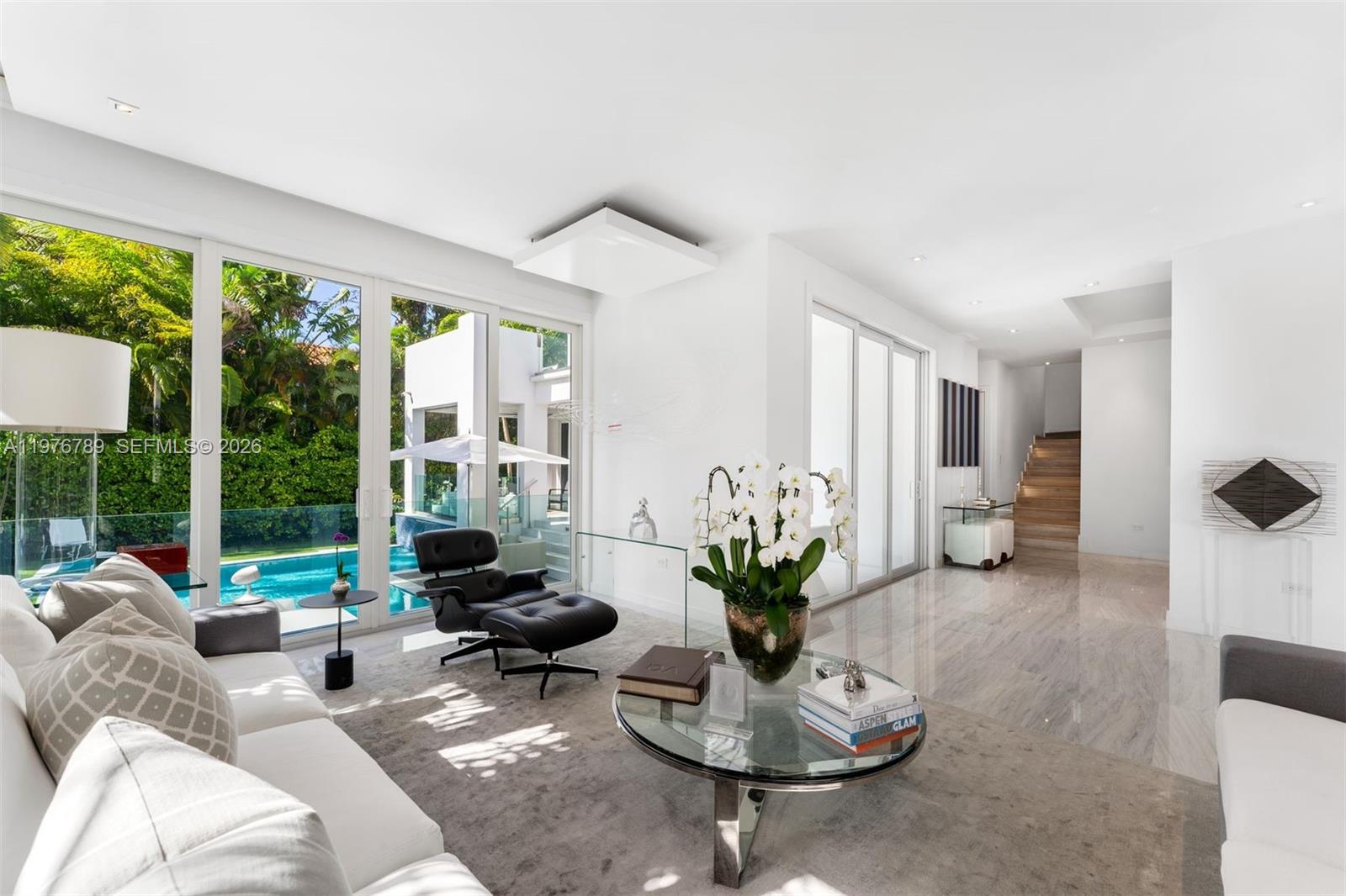 741 Harbor Drive Key Biscayne, FL 33149 - Photo 25 of 36 a living room with furniture potted plant and a large window