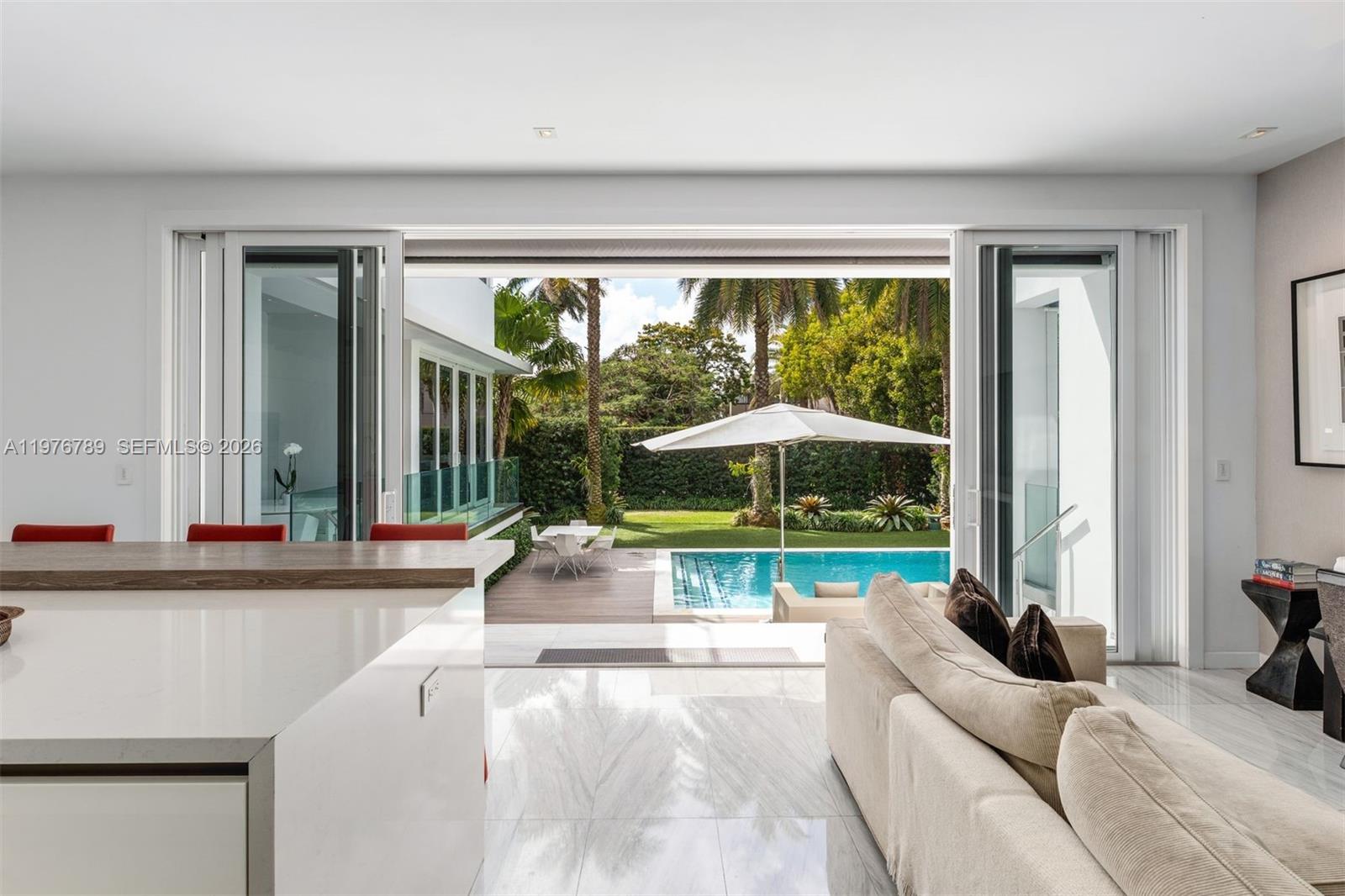 741 Harbor Drive Key Biscayne, FL 33149 - Photo 26 of 36 a living room with a floor to ceiling window and pool table