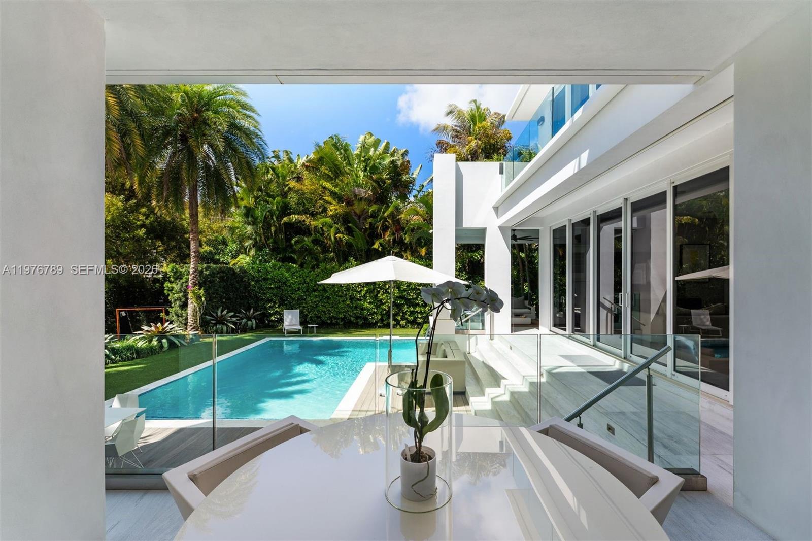 741 Harbor Drive Key Biscayne, FL 33149 - Photo 27 of 36 a view of a house with backyard sitting area and garden