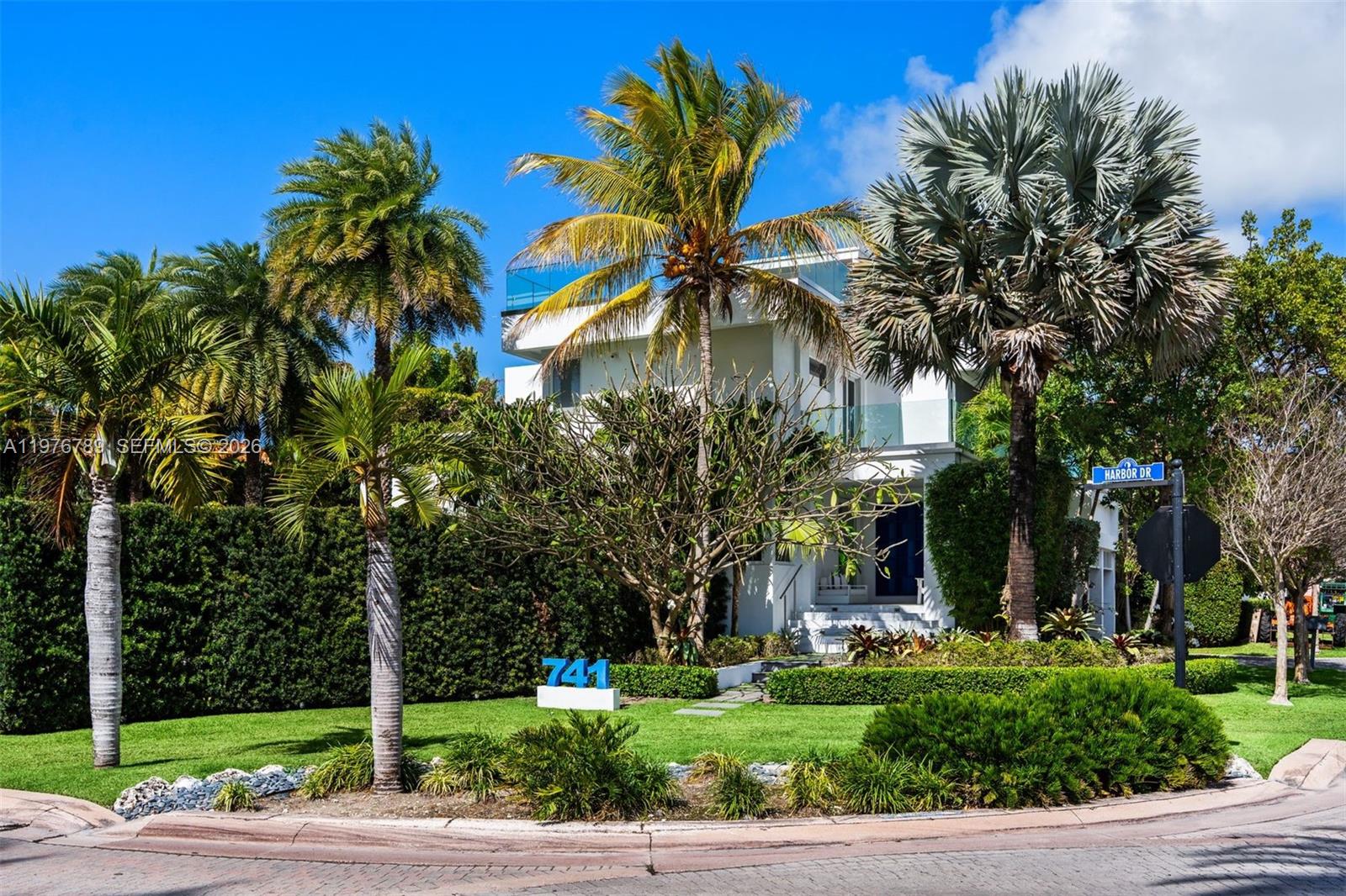741 Harbor Drive Key Biscayne, FL 33149 - Photo 3 of 36 a front view of multi story residential apartment building with yard and green space