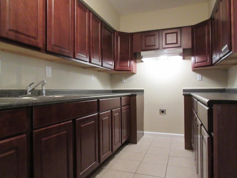 4202-04 Crain Road Memphis, TN 38128 - Photo 15 of 16 a kitchen with stainless steel appliances granite countertop a refrigerator and a sink