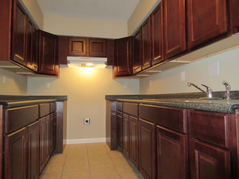 4202-04 Crain Road Memphis, TN 38128 - Photo 7 of 16 a kitchen with stainless steel appliances granite countertop wooden cabinets a stove a sink and dishwasher