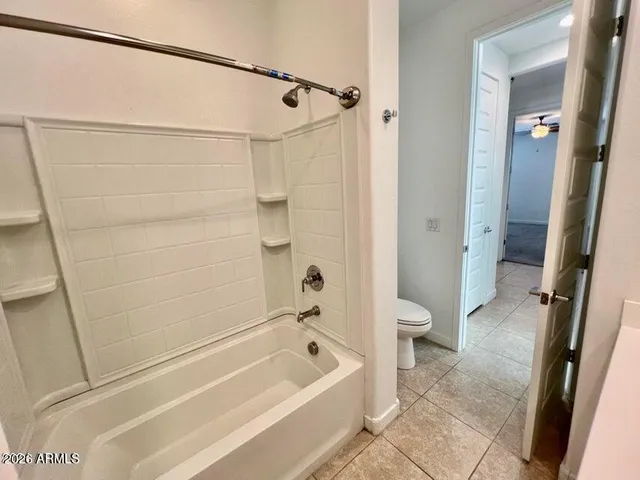a bathroom with a bathtub a toilet and a shower