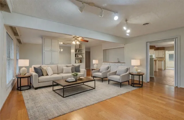 a living room with furniture and wooden floor