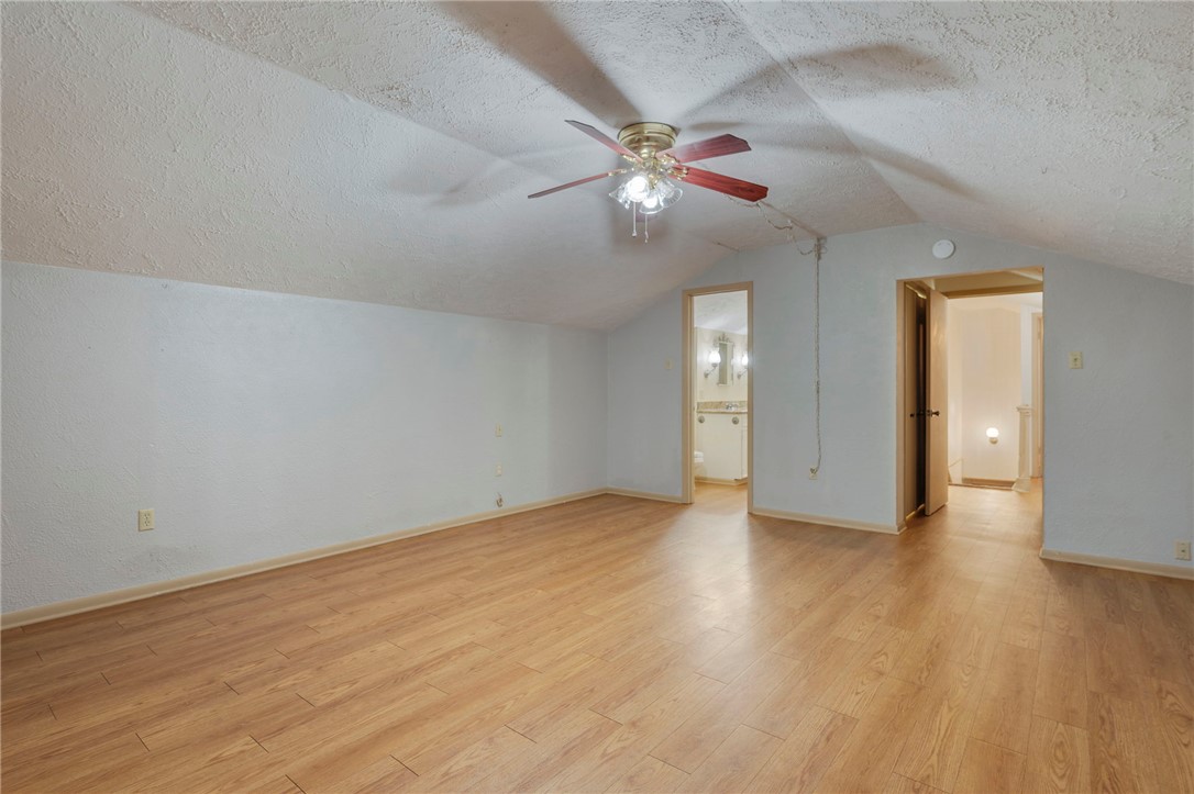 2606 Melba Circle Bryan, TX 77802 - Photo 24 of 34 a view of an empty room with wooden floor and a ceiling fan