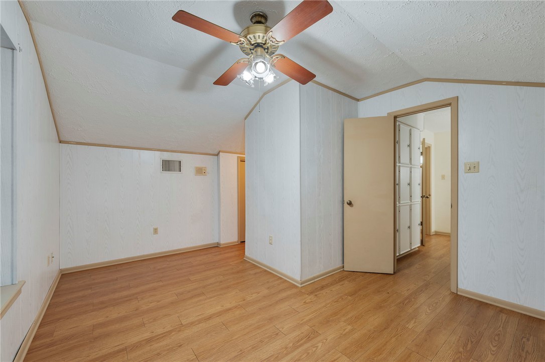 2606 Melba Circle Bryan, TX 77802 - Photo 25 of 34 an empty room with wooden floor fan and windows