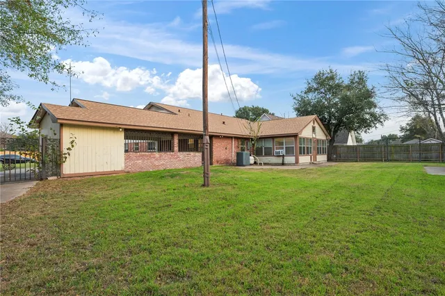an aerial view of a house with yard