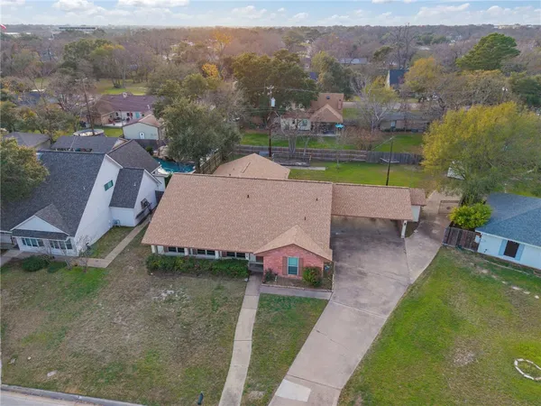 an aerial view of a house with a yard pool outdoor seating and yard