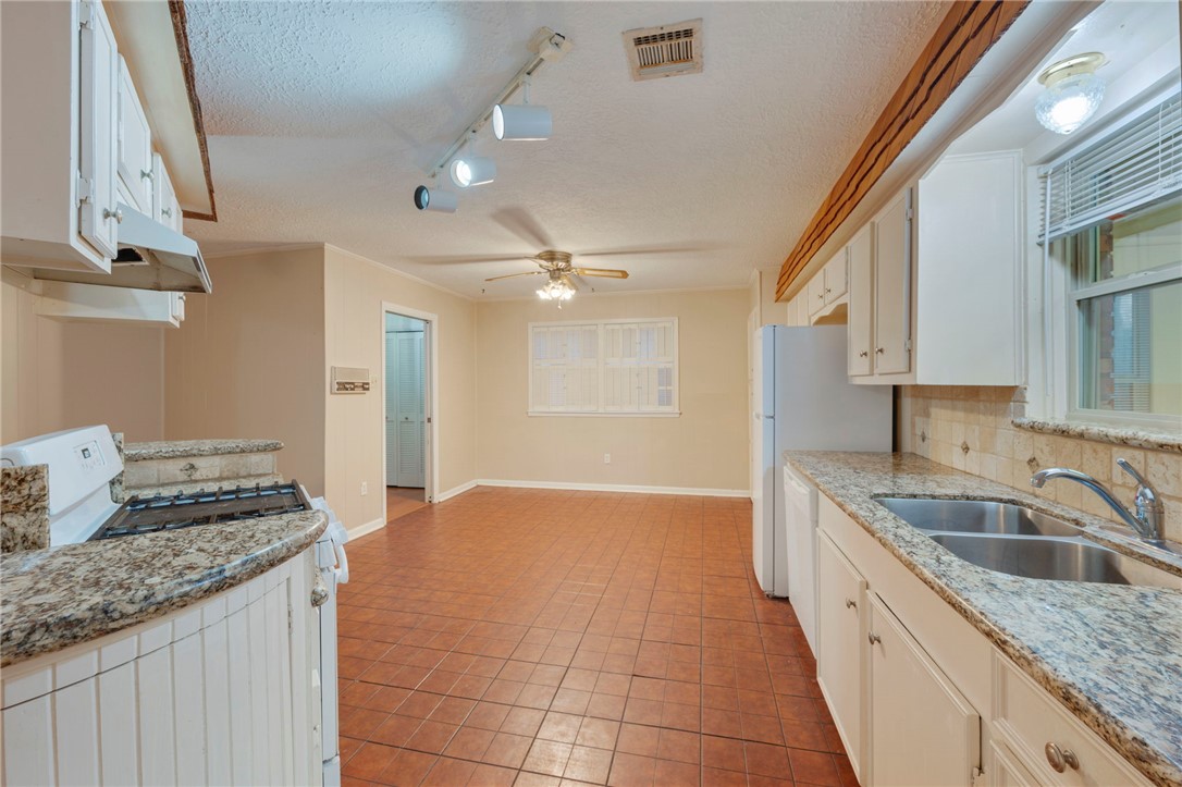 2606 Melba Circle Bryan, TX 77802 - Photo 7 of 34 a kitchen with granite countertop a sink and cabinets