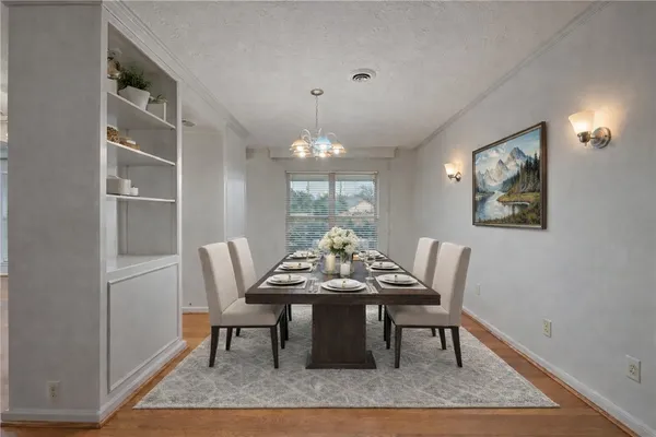 a view of a dining room with furniture window and wooden floor