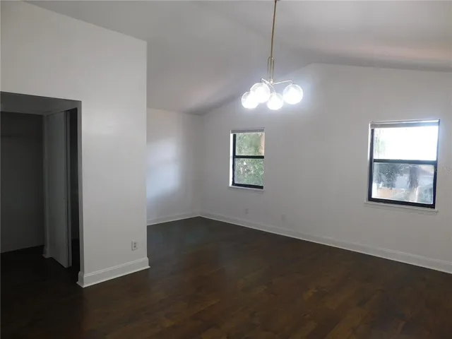 a view of a room with wooden floor and ceiling fan