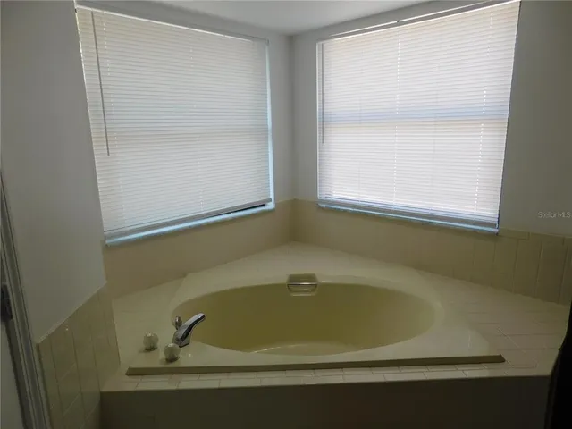 a white bath tub sitting next to a window