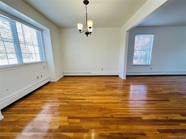 a view of a room with wooden floor and chandelier