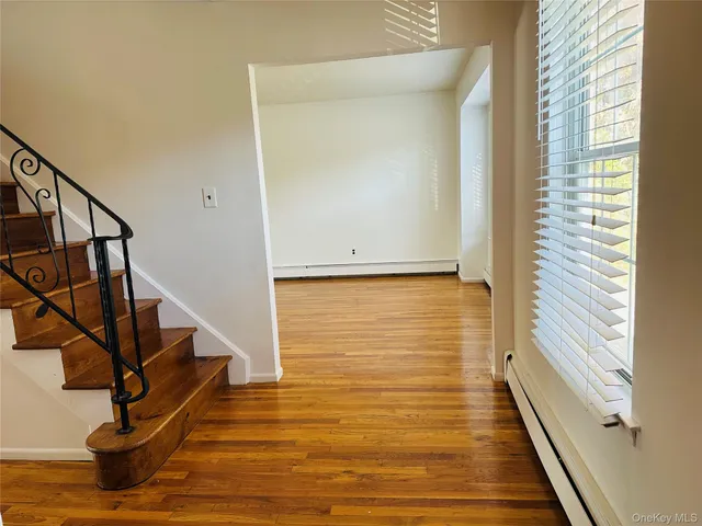 a view of a room with wooden floor and staircase