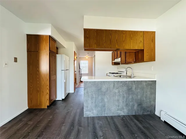 a view of a kitchen with wooden floor and a sink
