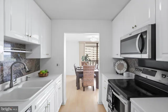 a kitchen with a refrigerator and a sink