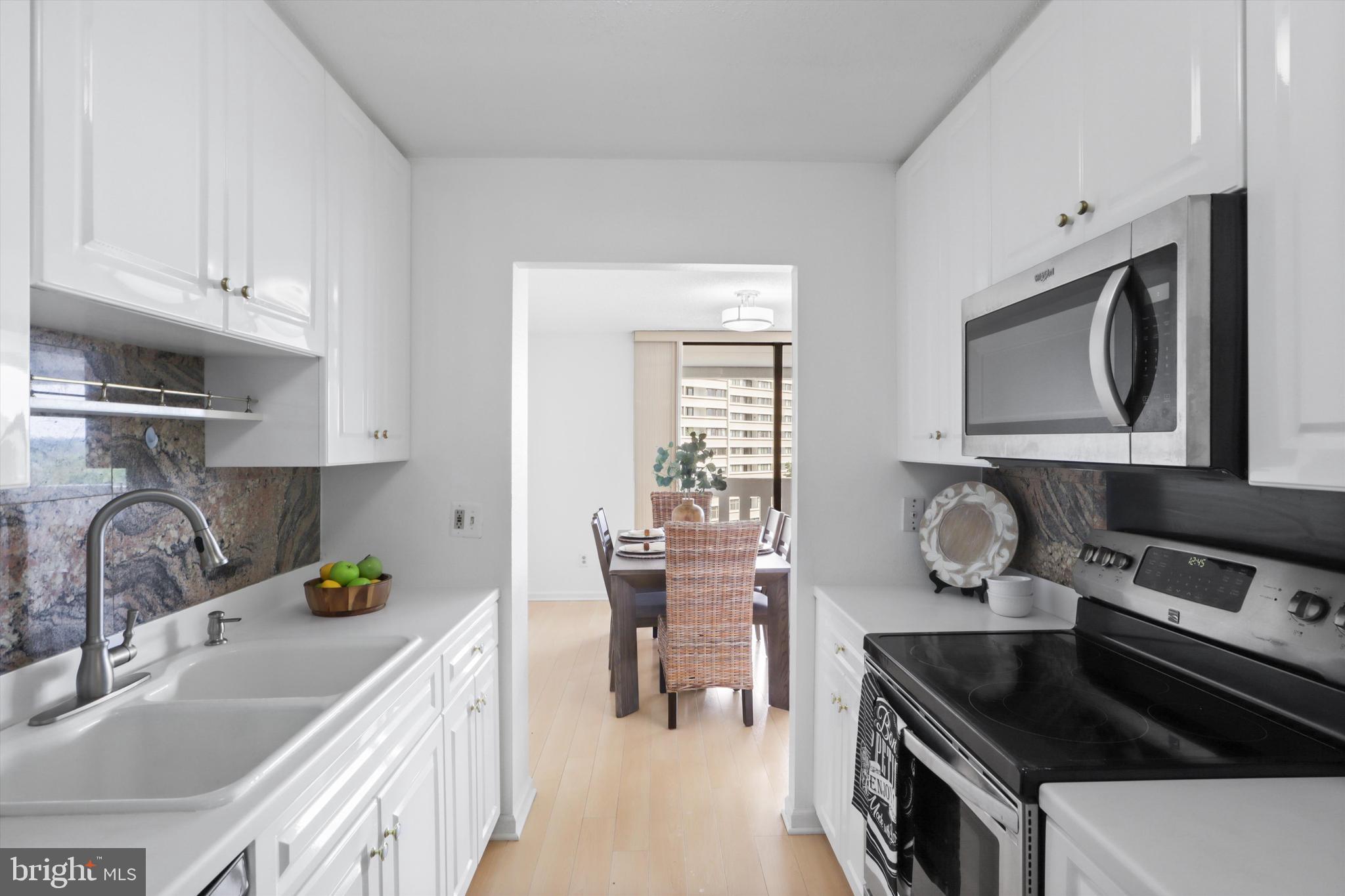 6101 Edsall Road, Unit 611 Alexandria, VA 22304 - Photo 14 of 39 a kitchen with granite countertop a sink stove and cabinets