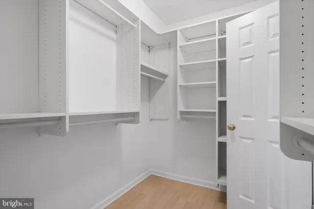 a spacious bedroom with a bed and a large window