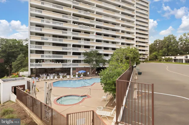 a kitchen with stainless steel appliances granite countertop a sink a stove and a wooden floors