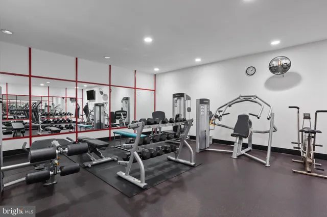 a kitchen view with a counter space a sink a refrigerator and chandelier