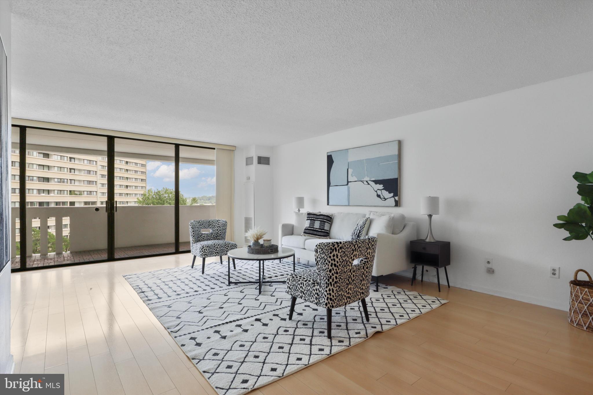 6101 Edsall Road, Unit 611 Alexandria, VA 22304 - Photo 9 of 39 a living room with furniture and a large window