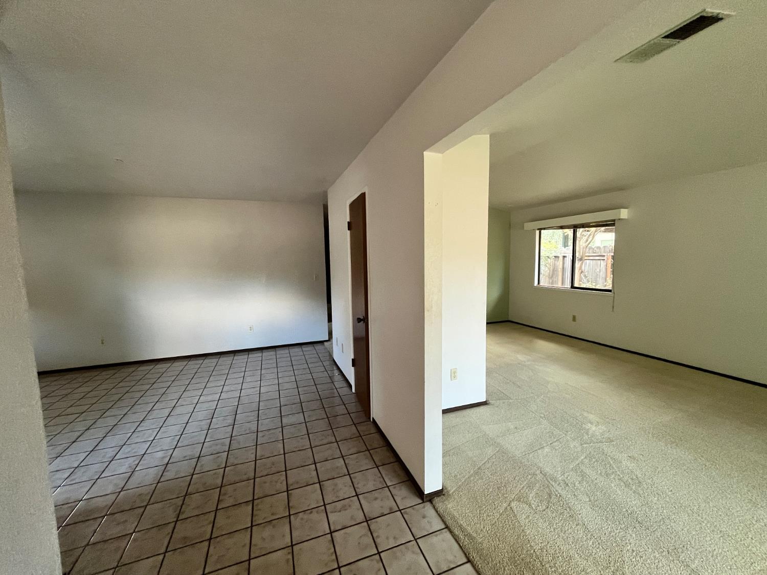 312 Roxanne Drive Patterson, CA 95363 - Photo 11 of 28 a view of a hallway with an empty room and window