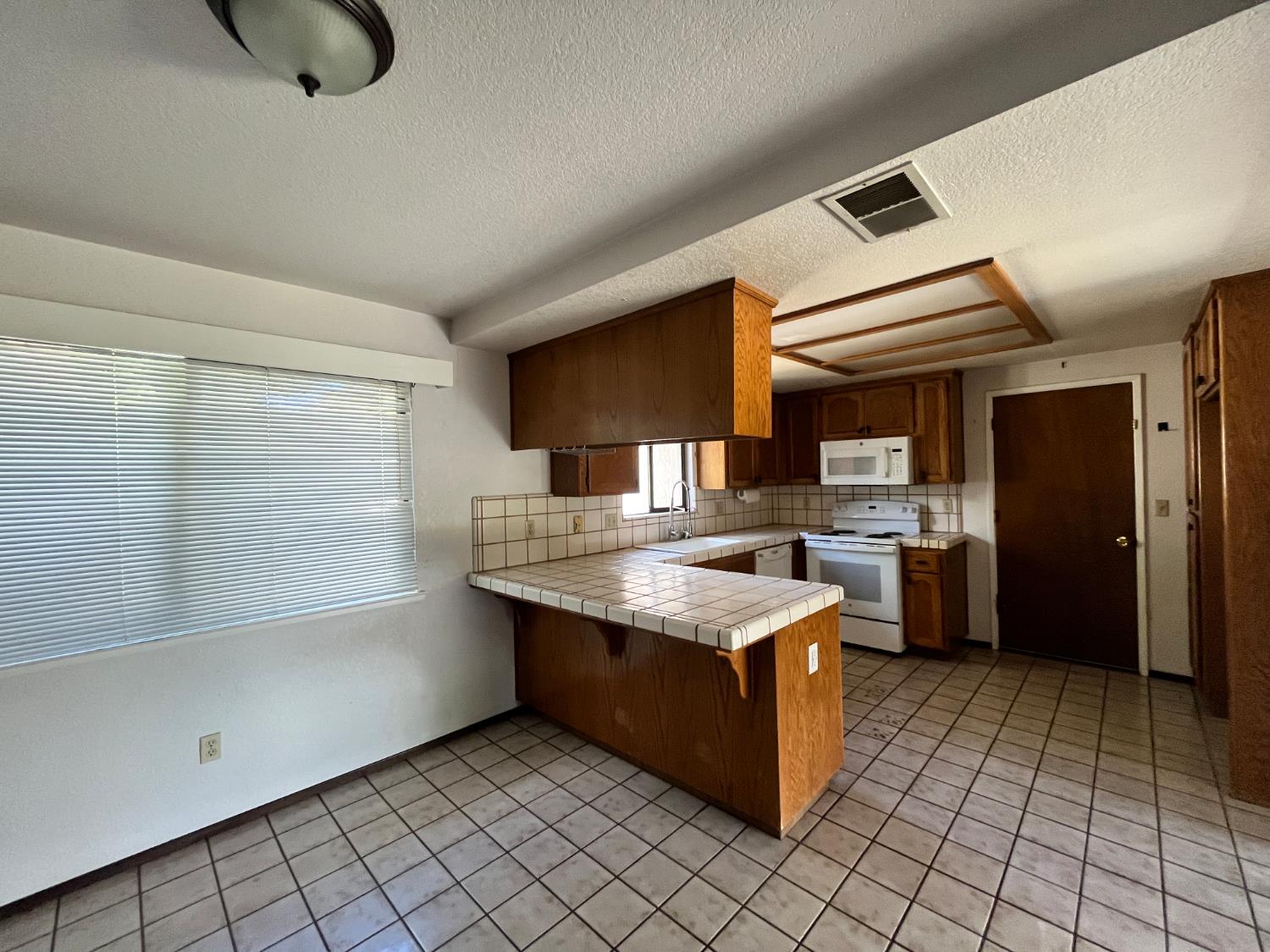 312 Roxanne Drive Patterson, CA 95363 - Photo 15 of 28 a kitchen with stainless steel appliances granite countertop a stove a refrigerator and a cabinets