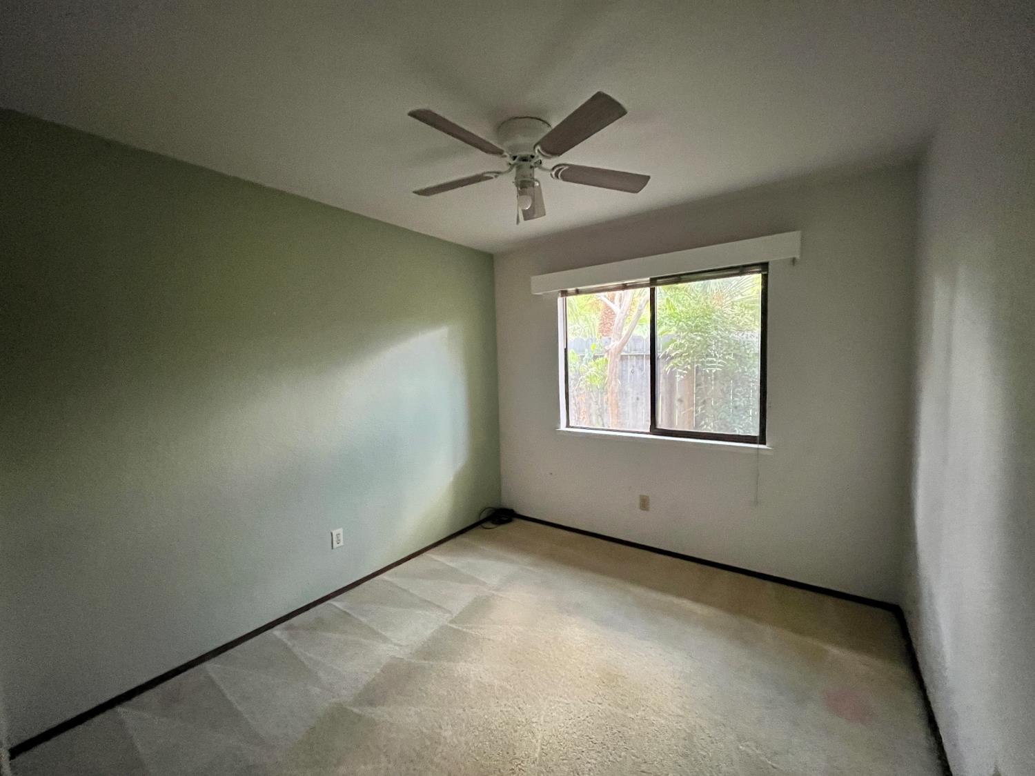 312 Roxanne Drive Patterson, CA 95363 - Photo 20 of 28 an empty room with a window and a fan