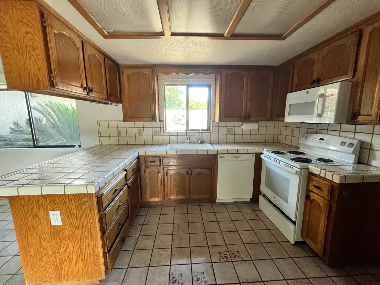 312 Roxanne Drive Patterson, CA 95363 - Photo 2 of 28 a kitchen with a sink stove top oven and cabinets
